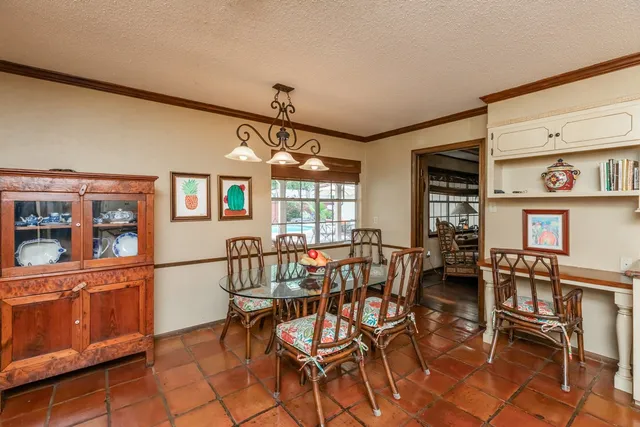 a room with pool table and windows