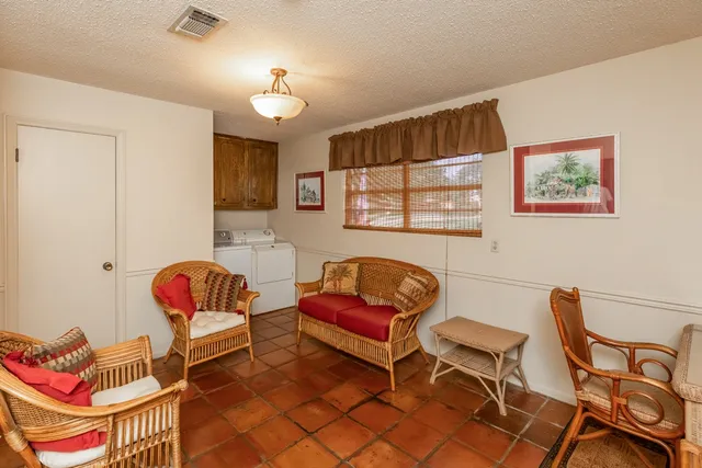 a bedroom with a bed and large windows