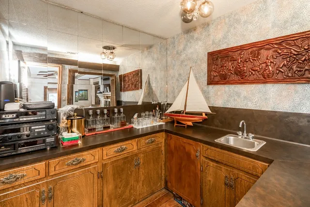 a view of a patio with dining table and chairs with a small yard