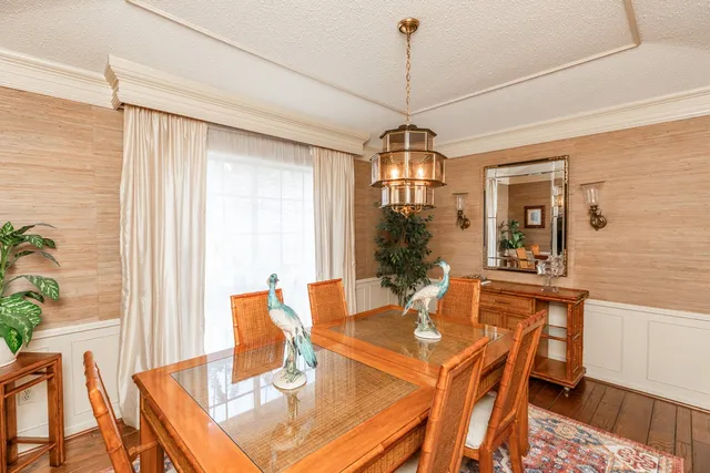 a view of a dining room with furniture and chandelier