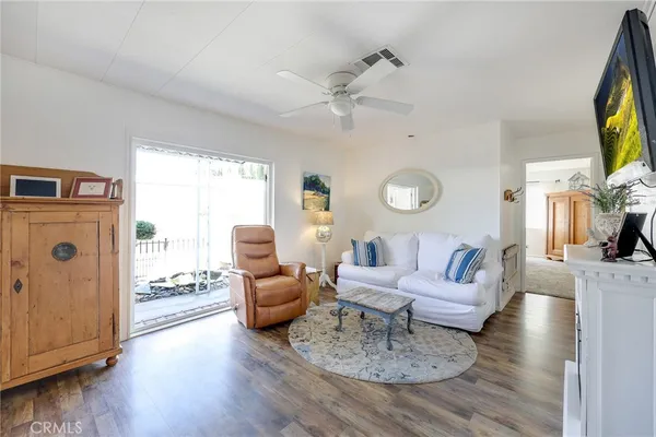 a kitchen with stainless steel appliances a sink a stove a refrigerator cabinets and a dining table