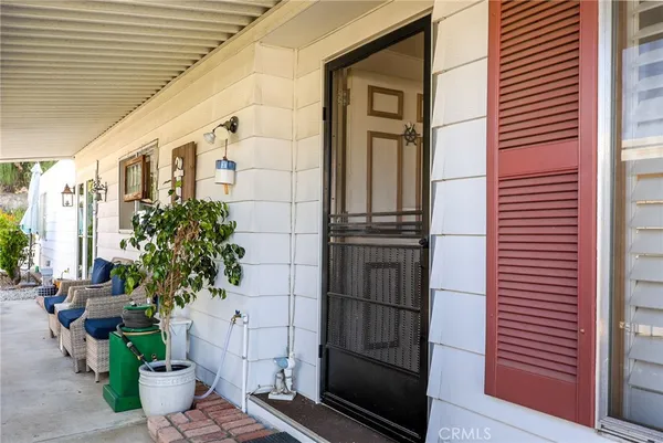 a front view of a house with a potted plant