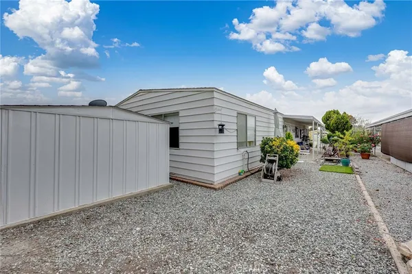 a front view of small house with yard and green space