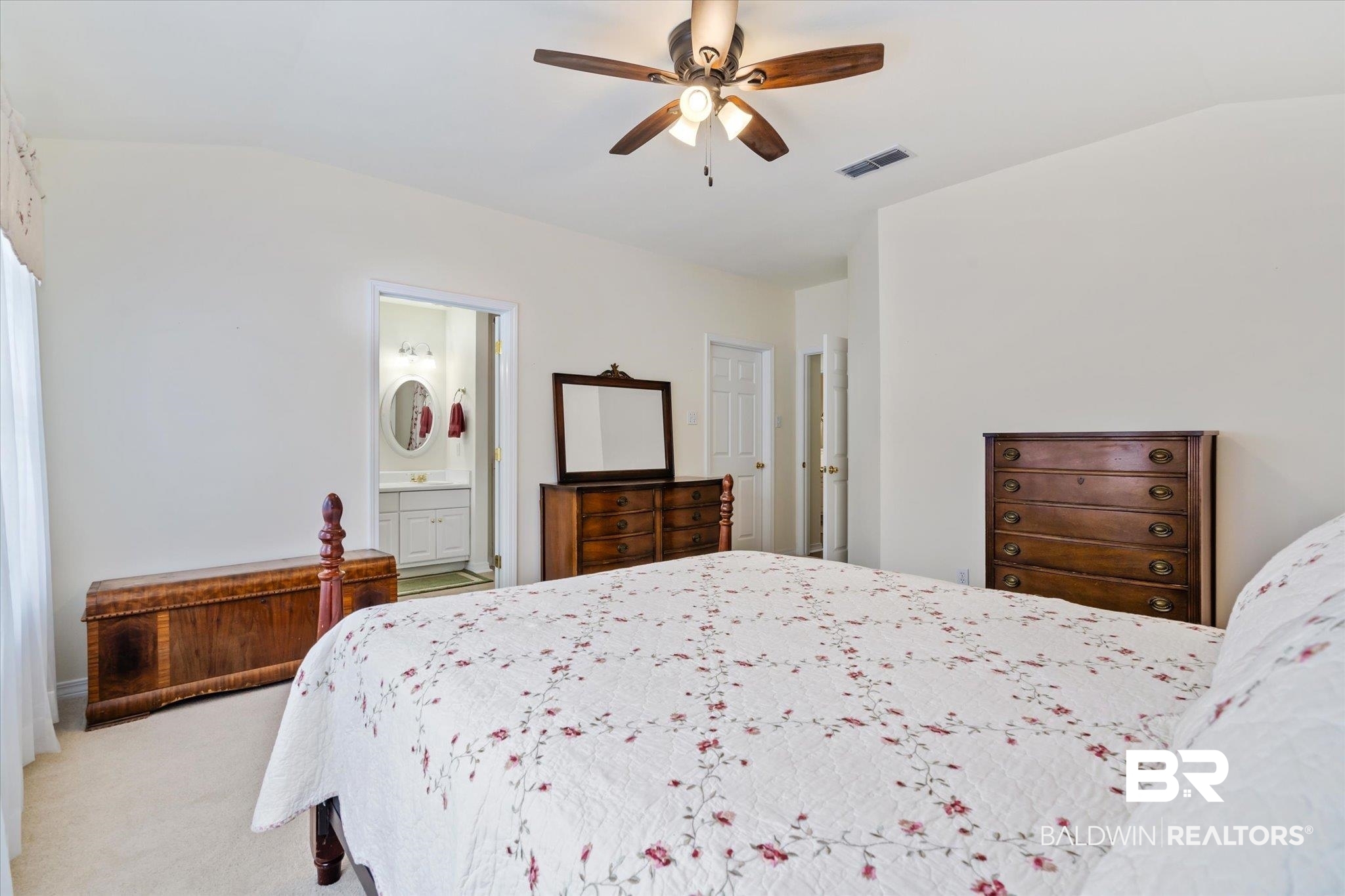 7236 Highpointe Place East Daphne, AL 36527 - Photo 15 of 32 Carpeted bedroom with vaulted ceiling, connected bathroom, and ceiling fan