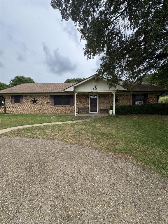 636 East Kempner Street Mabank, TX 75147 - Photo 2 of 28 Brick exterior residence with a covered front porch and mature trees