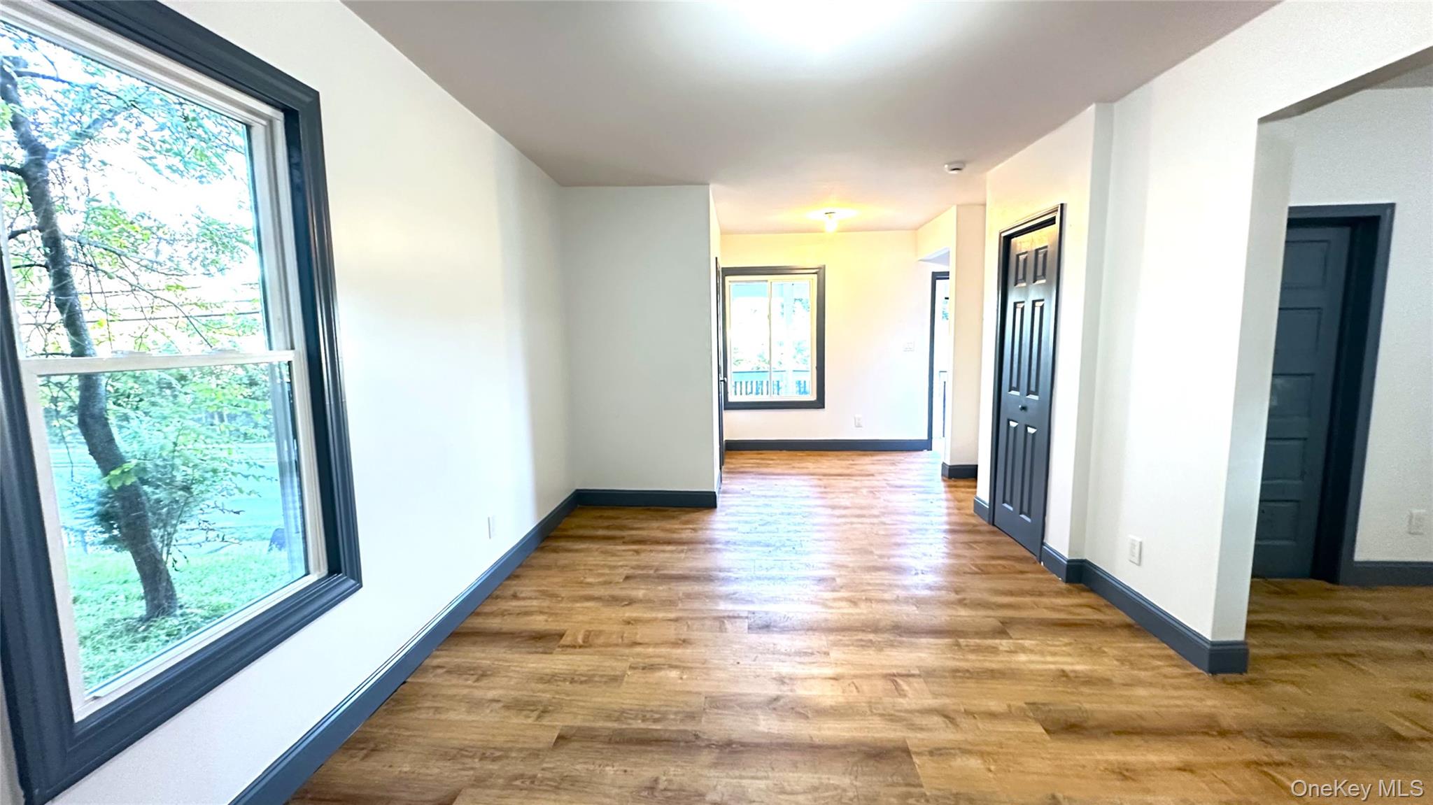 154 Smith Street Poughkeepsie, NY 12601 - Photo 4 of 13 a view of a hallway with wooden floor and windows