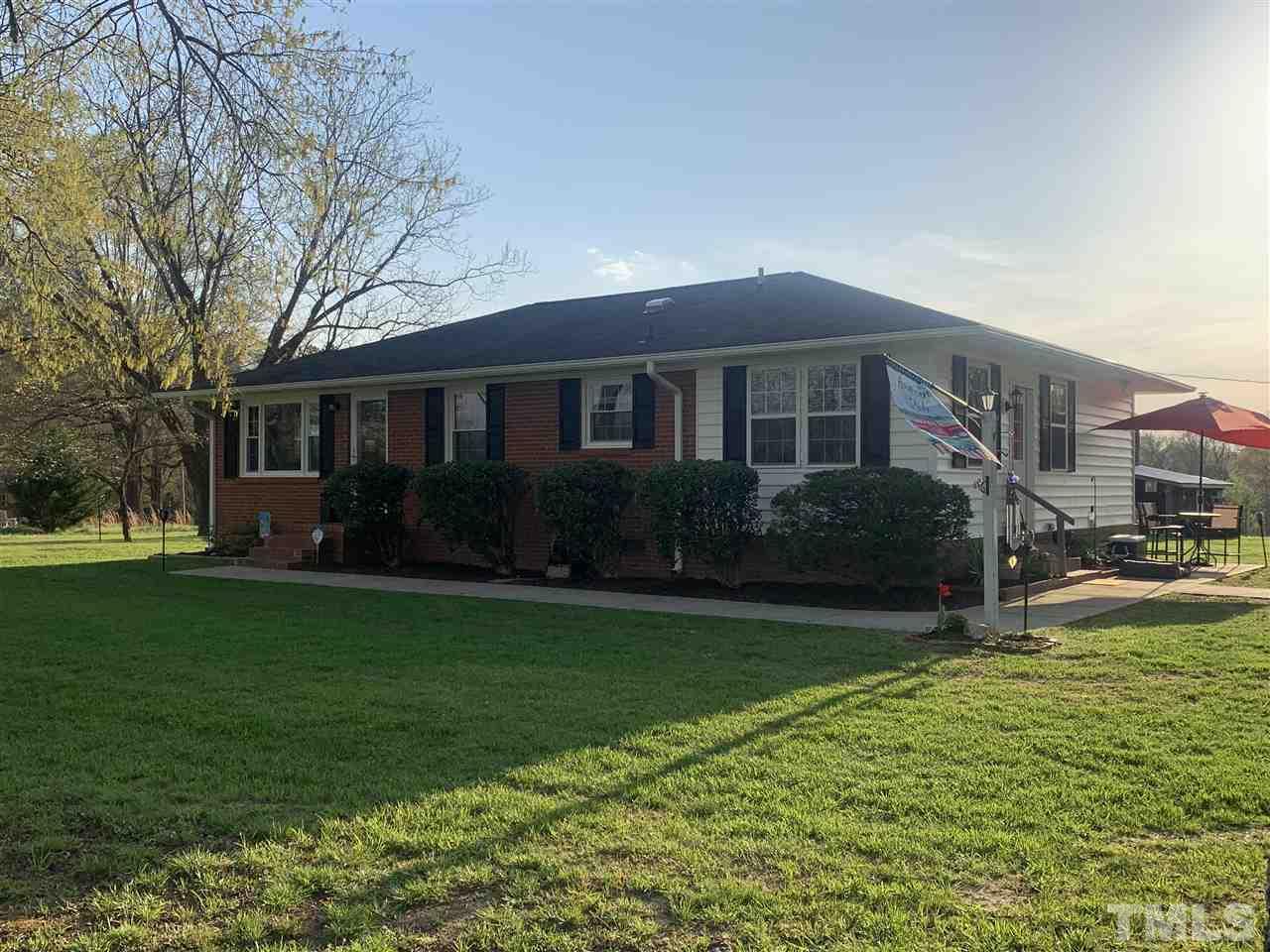 8609 Cassam Road Bahama, NC 27503 - Photo 1 of 23 a front view of house with yard and green space