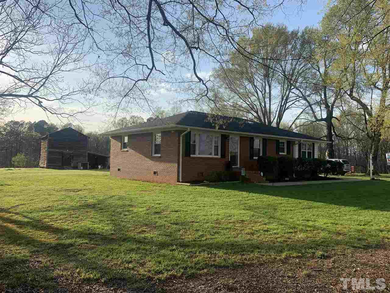 8609 Cassam Road Bahama, NC 27503 - Photo 2 of 23 a front view of a house with a garden