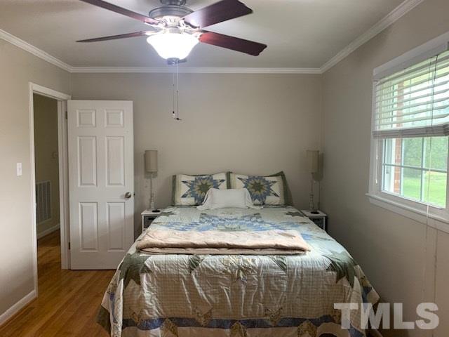 8609 Cassam Road Bahama, NC 27503 - Photo 13 of 23 a bed sitting in a bedroom next to a window