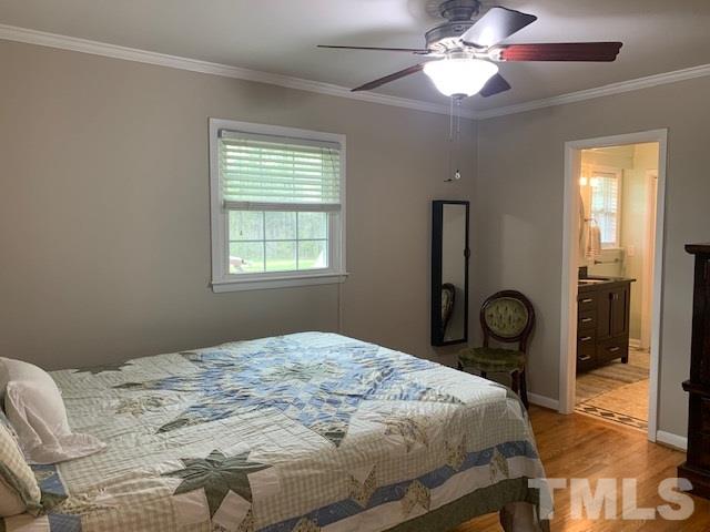 8609 Cassam Road Bahama, NC 27503 - Photo 14 of 23 a bedroom with a bed and a chandelier
