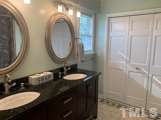 8609 Cassam Road Bahama, NC 27503 - Photo 15 of 23 a bathroom with a sink and a mirror