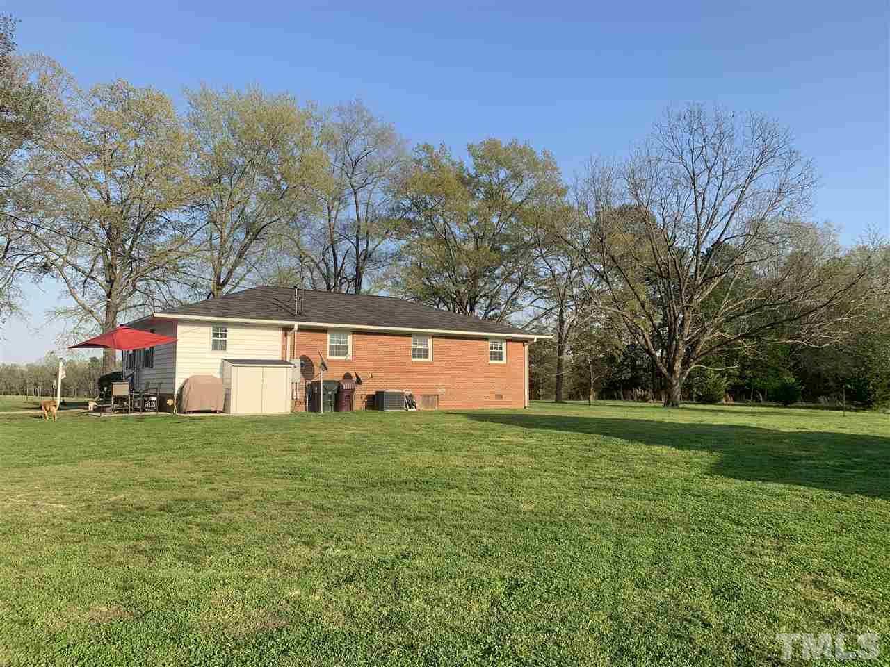 8609 Cassam Road Bahama, NC 27503 - Photo 3 of 23 a view of a house with a yard and a large tree