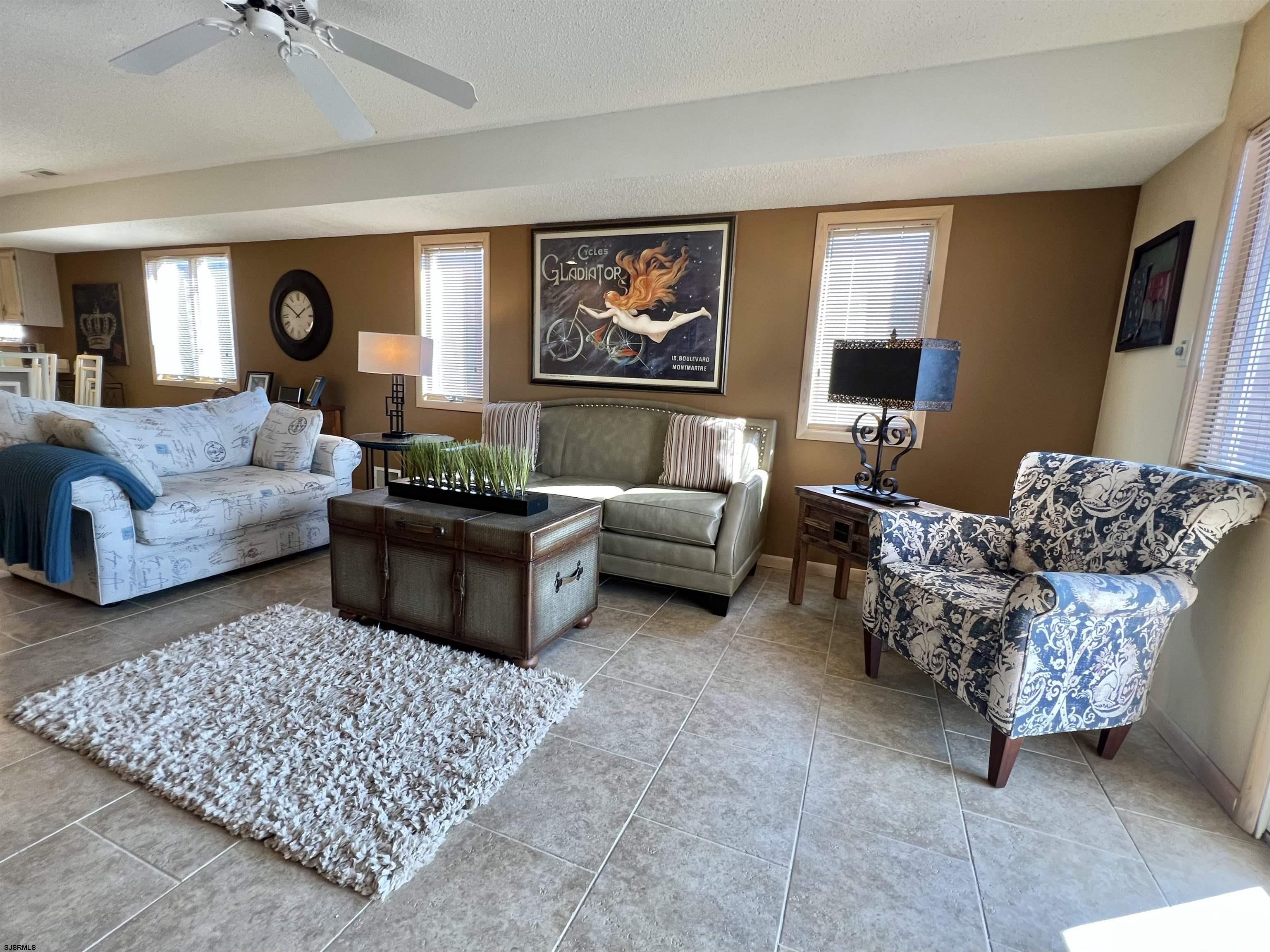 211 3rd Street North, Unit B Brigantine, NJ 08203 - Photo 14 of 52 a living room with furniture and a rug
