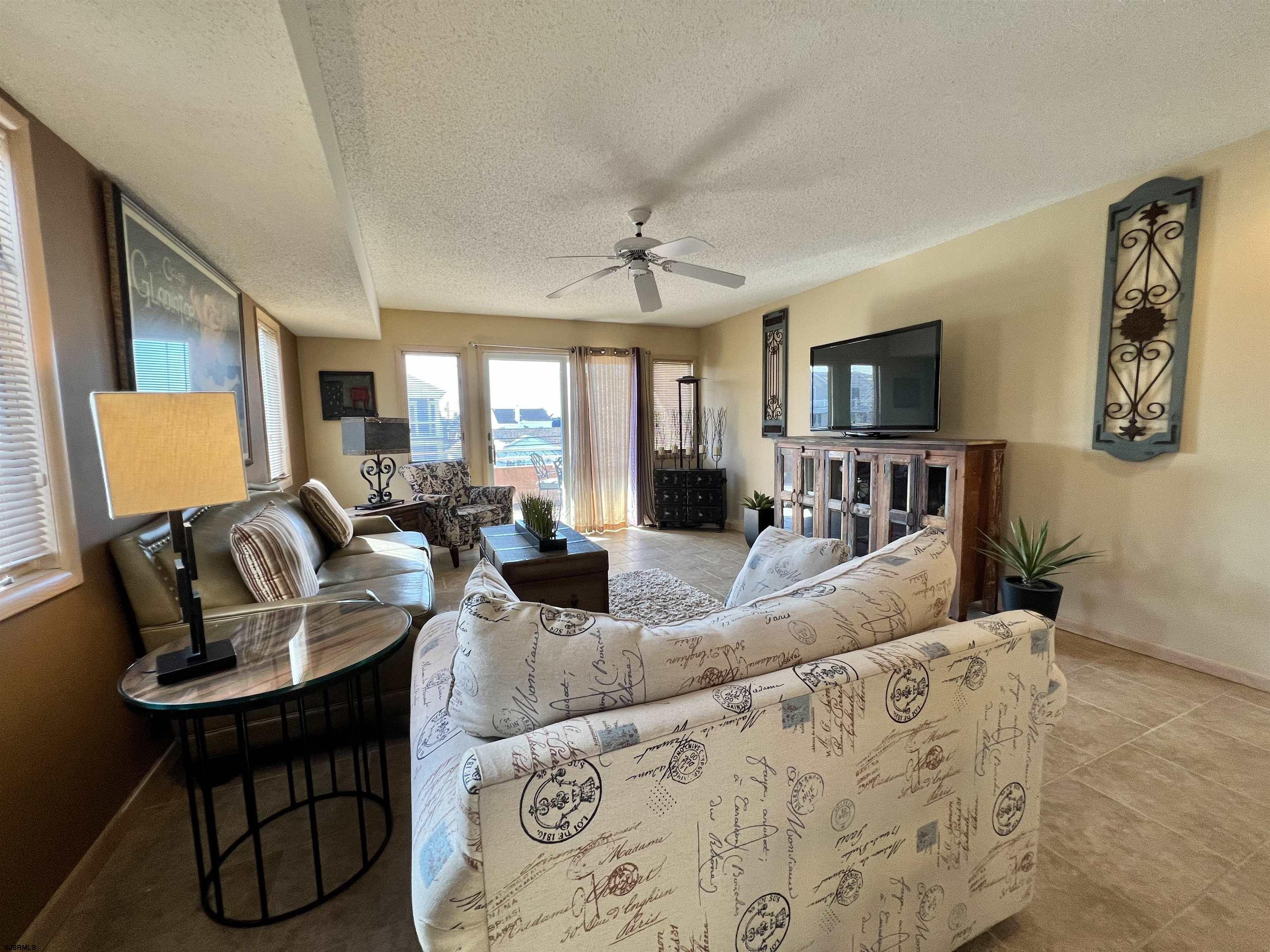211 3rd Street North, Unit B Brigantine, NJ 08203 - Photo 17 of 52 a living room with furniture and a flat screen tv