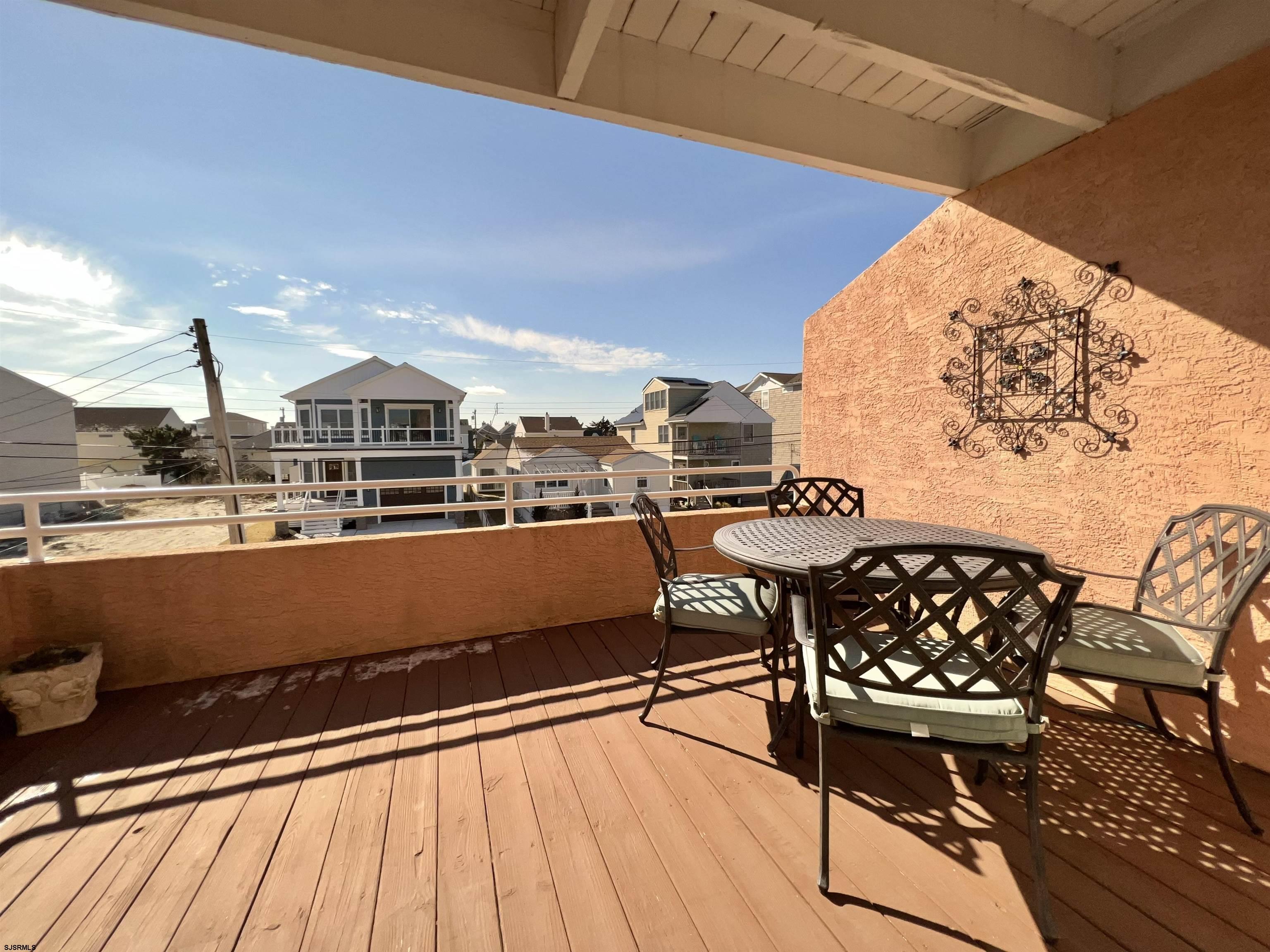211 3rd Street North, Unit B Brigantine, NJ 08203 - Photo 23 of 52 a view of a chairs and table in the terrace