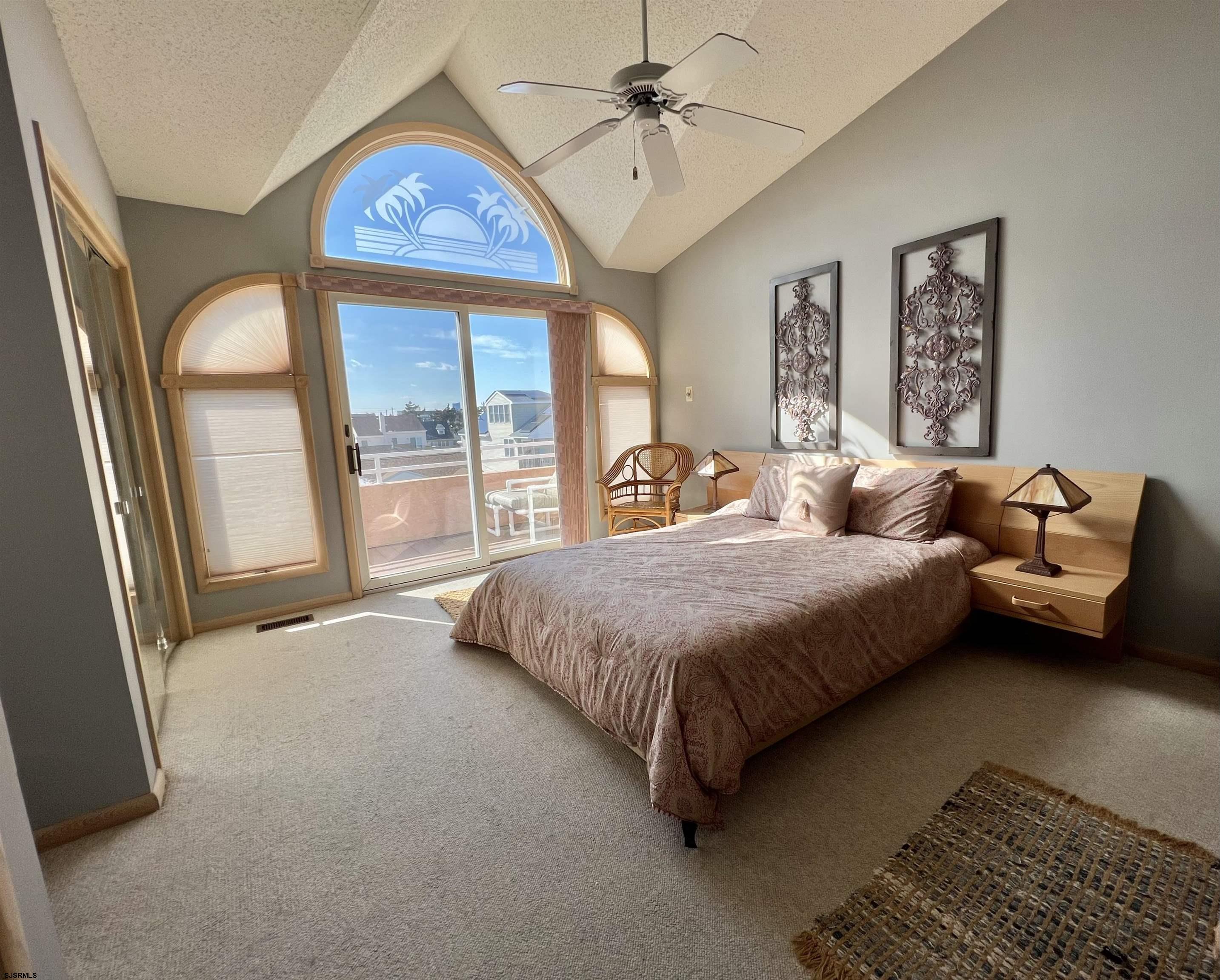 211 3rd Street North, Unit B Brigantine, NJ 08203 - Photo 26 of 52 a bedroom with a bed couch and window