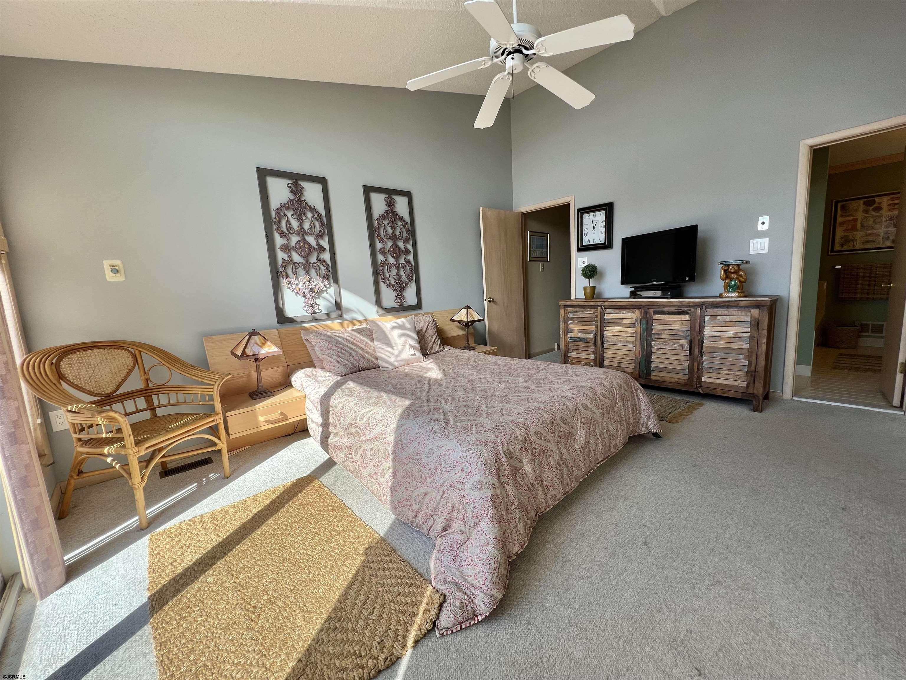 211 3rd Street North, Unit B Brigantine, NJ 08203 - Photo 28 of 52 a bedroom with a bed and a flat screen tv