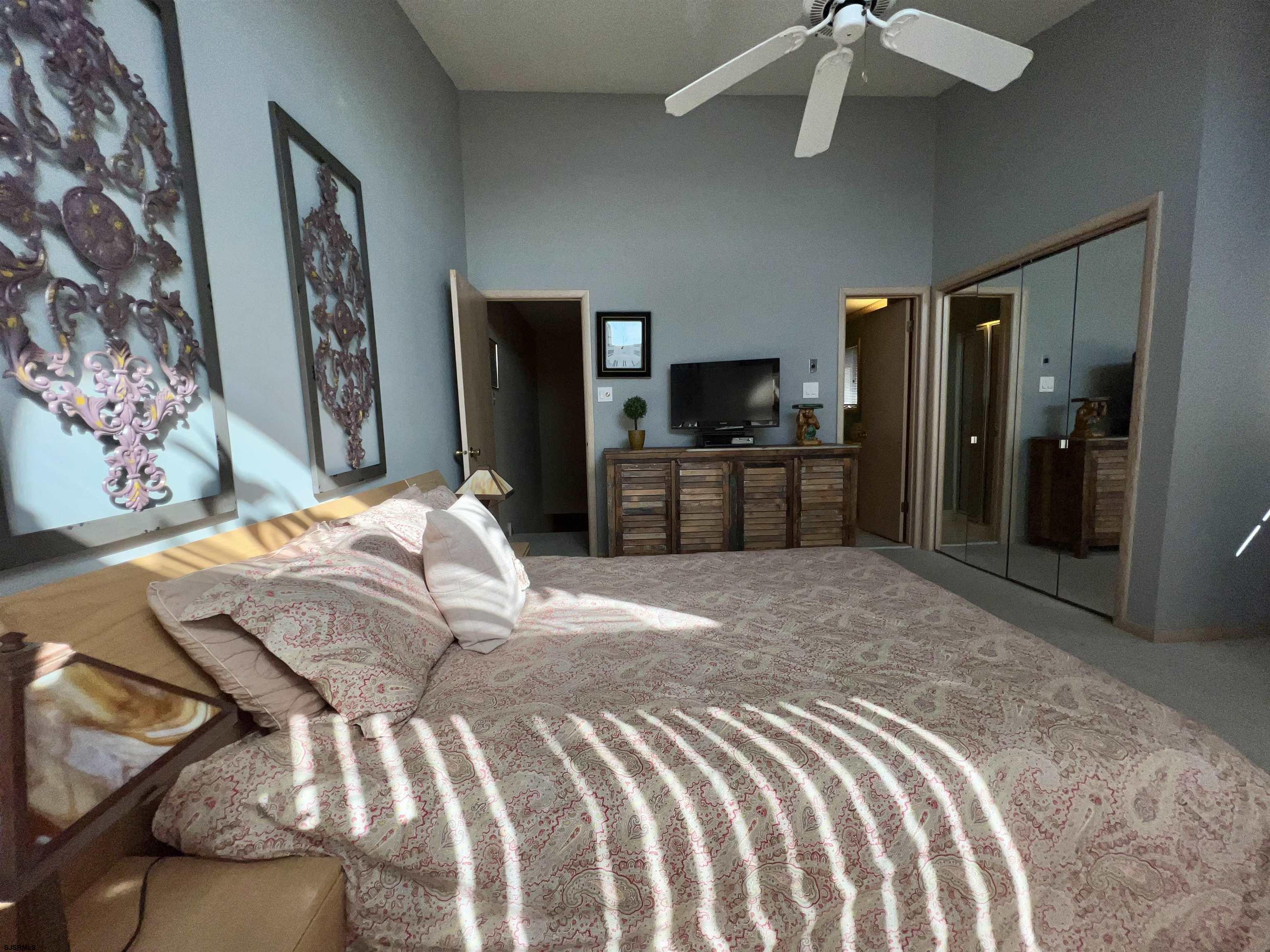 211 3rd Street North, Unit B Brigantine, NJ 08203 - Photo 29 of 52 a bedroom with a bed and wooden floor