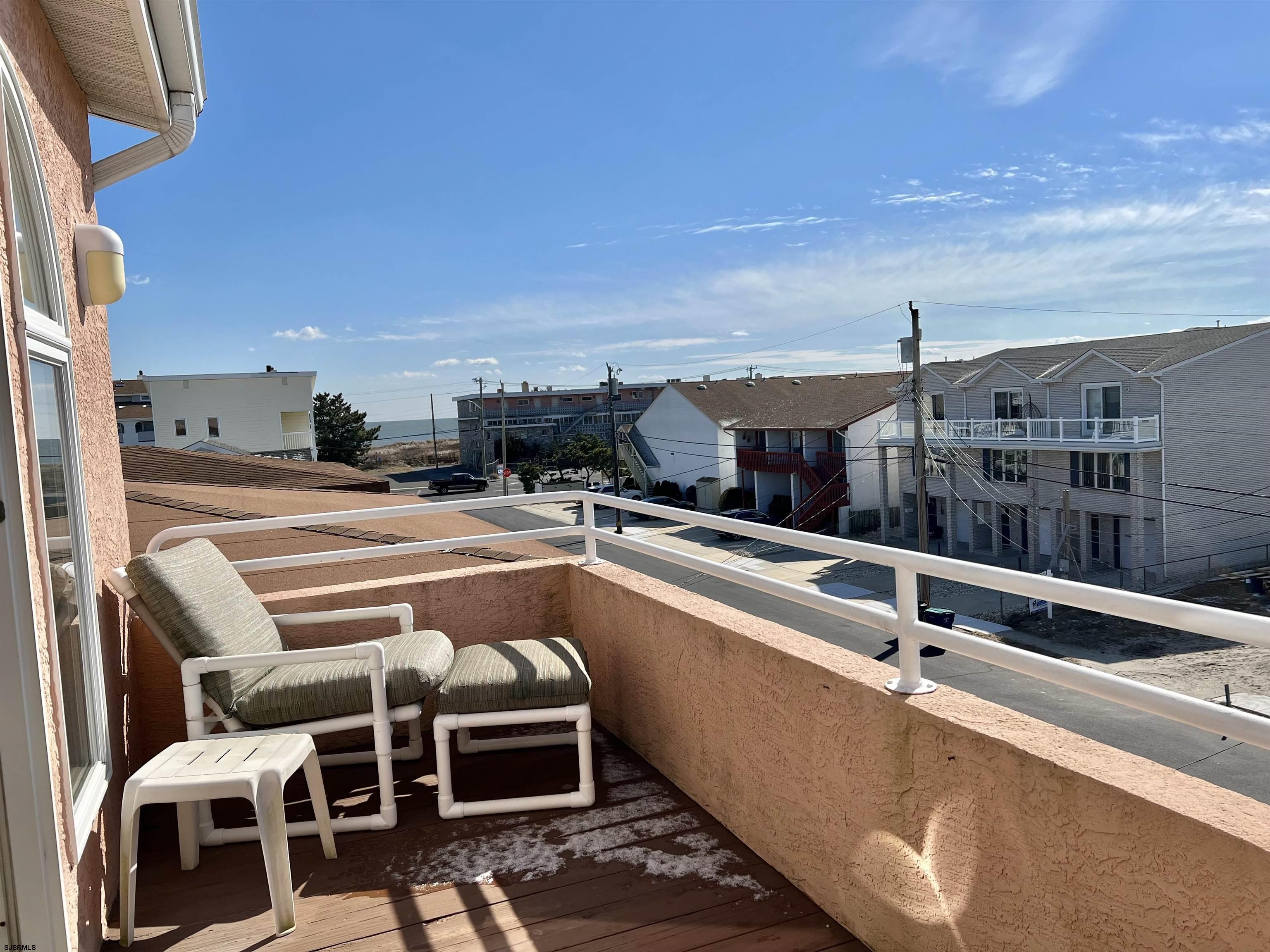 211 3rd Street North, Unit B Brigantine, NJ 08203 - Photo 30 of 52 a view of a balcony with two chairs and a table