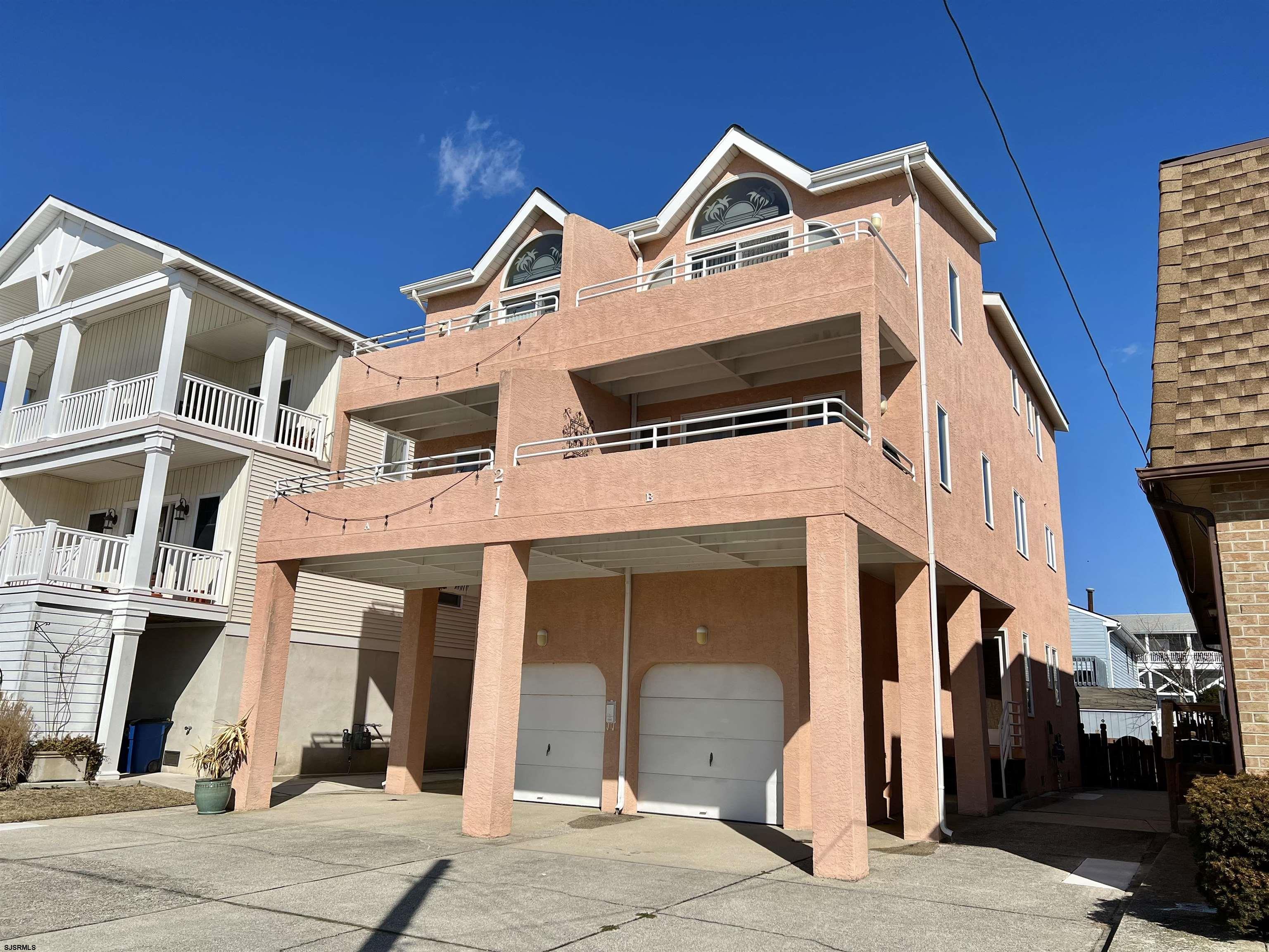 211 3rd Street North, Unit B Brigantine, NJ 08203 - Photo 3 of 52 a front view of a house with a garage