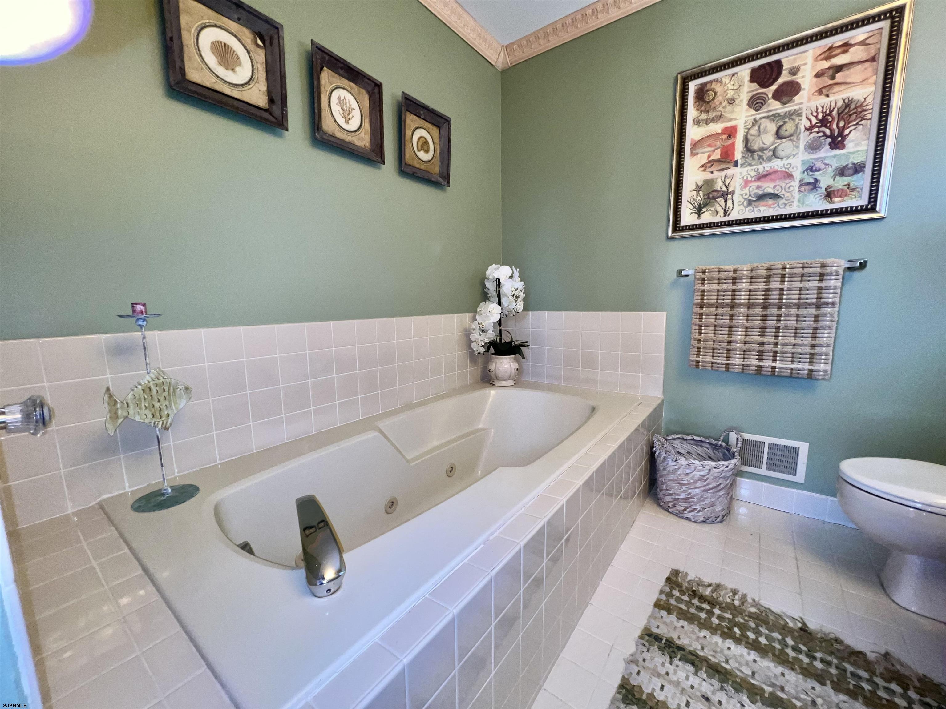 211 3rd Street North, Unit B Brigantine, NJ 08203 - Photo 34 of 52 a bathroom with a bathtub and a toilet