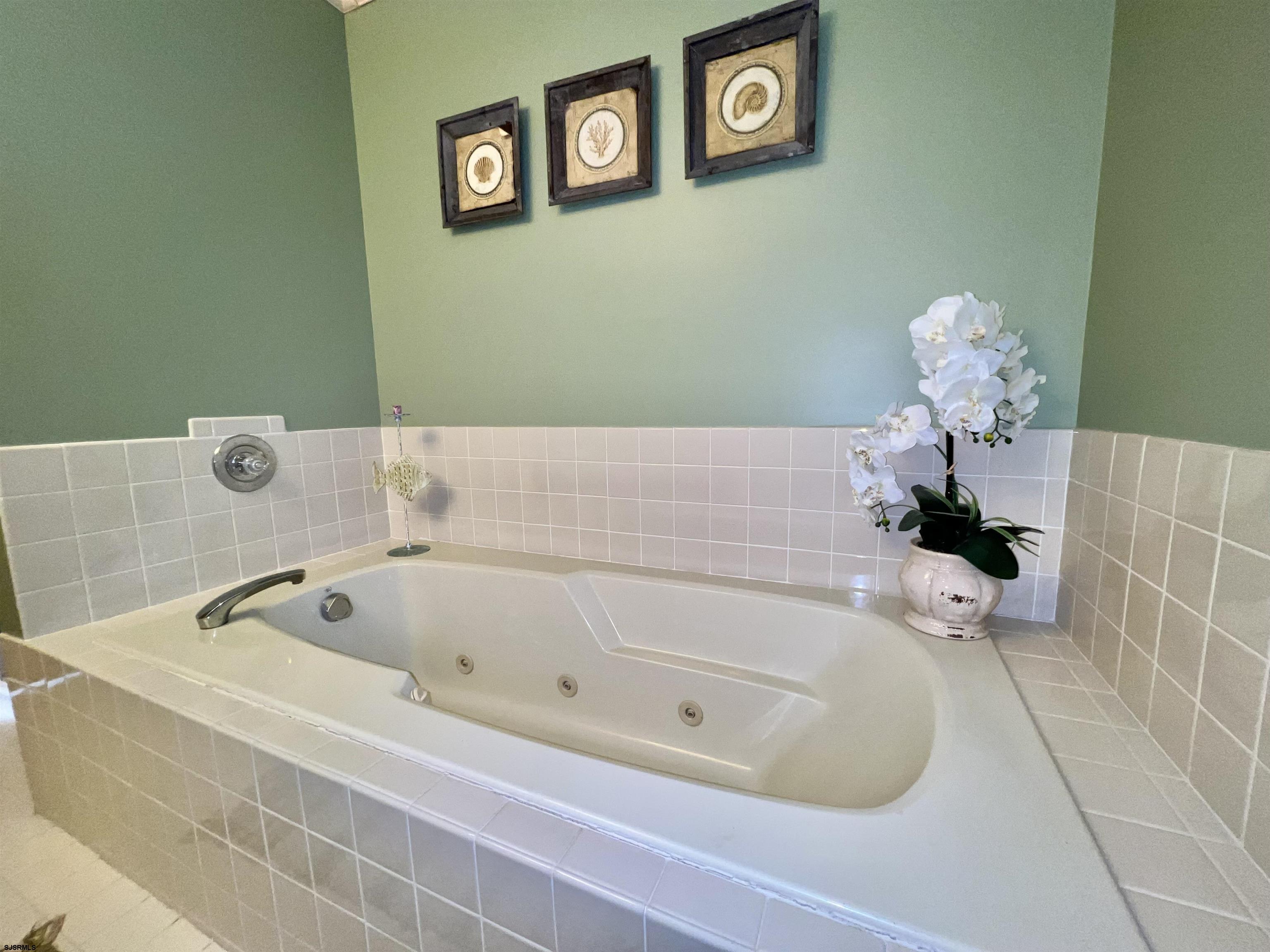 211 3rd Street North, Unit B Brigantine, NJ 08203 - Photo 35 of 52 a white bath tub sitting next to a white wall