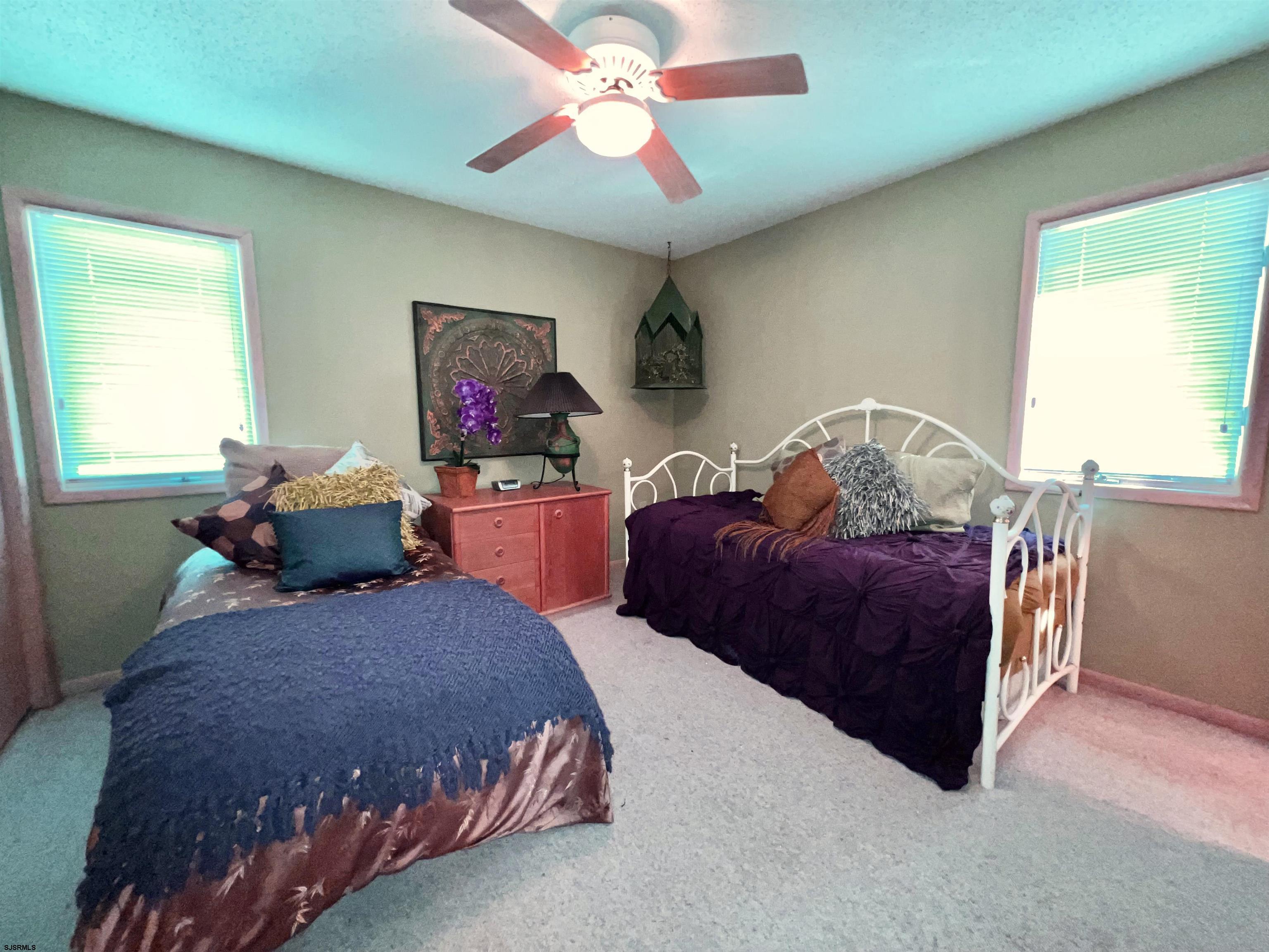 211 3rd Street North, Unit B Brigantine, NJ 08203 - Photo 38 of 52 a bedroom with a bed and window