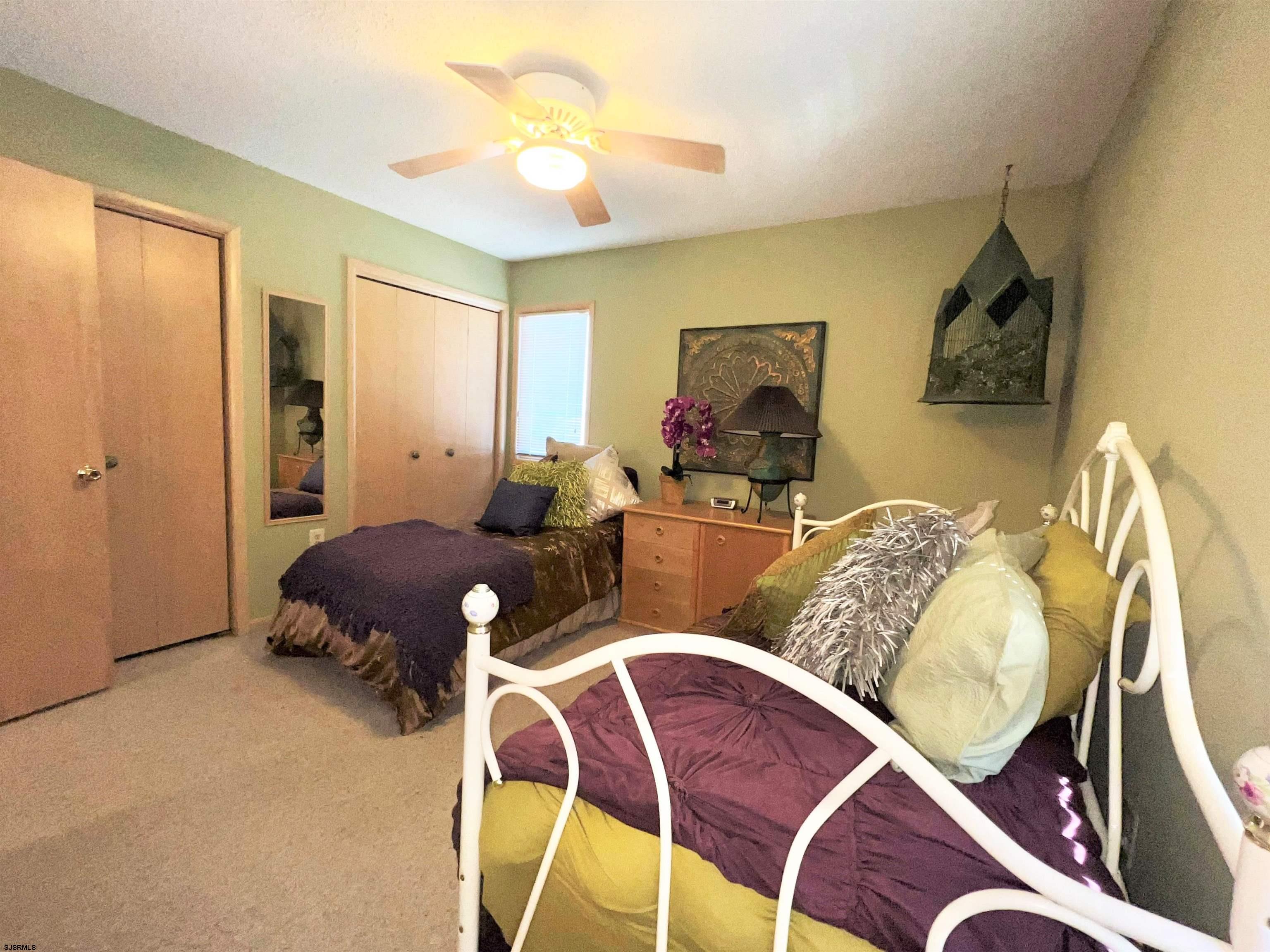211 3rd Street North, Unit B Brigantine, NJ 08203 - Photo 39 of 52 a living room with furniture a wooden floor and a chandelier