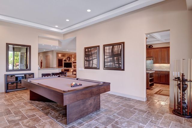 a room with pool table and window