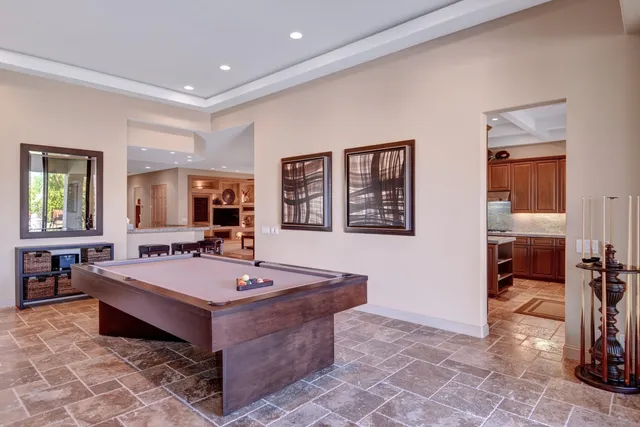 a room with pool table and window