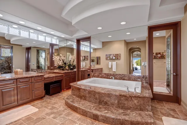 a large bathroom with a large tub and sink
