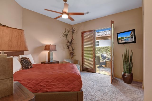 a bedroom with a bed and a lamp