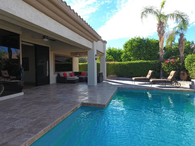 a view of swimming pool with outdoor seating and lake view