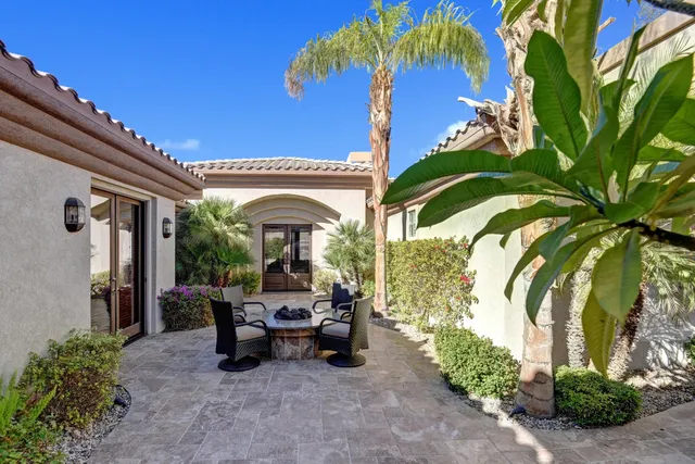 a view of a patio with table and chairs and potted plants