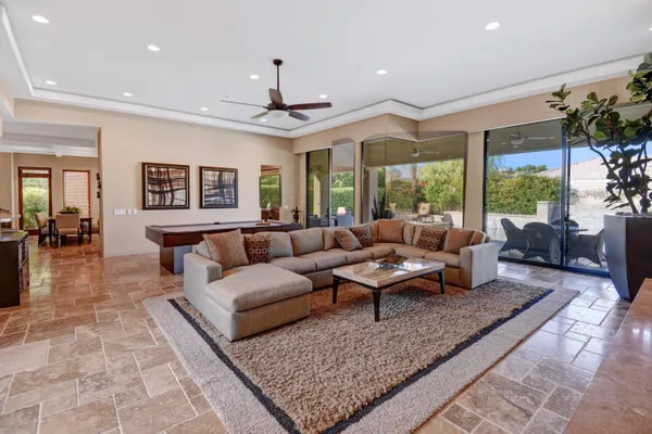 a living room with furniture and a chandelier