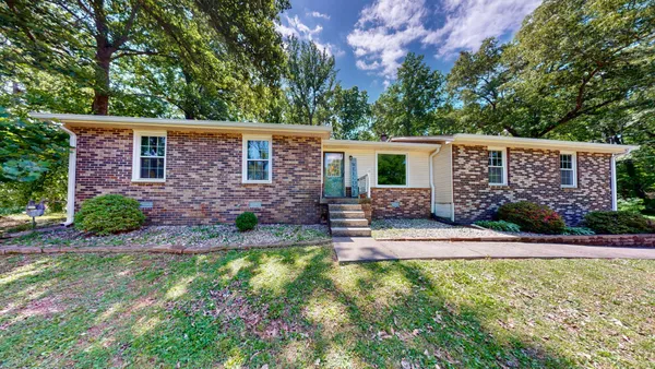 a view of a house with a backyard