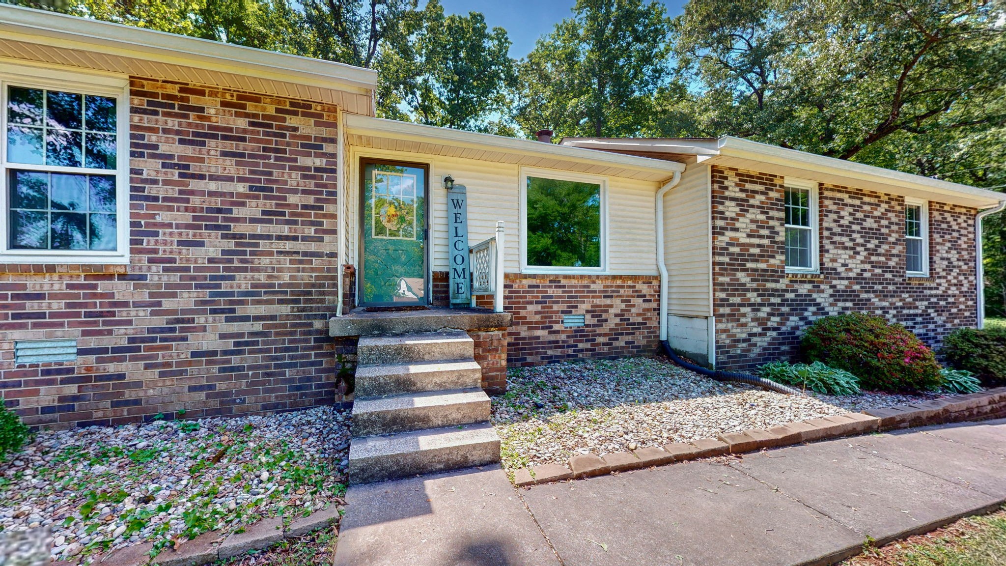 268 Raymond Hodges Road Cottontown, TN 37048 - Photo 2 of 38 a front view of a house with a garden