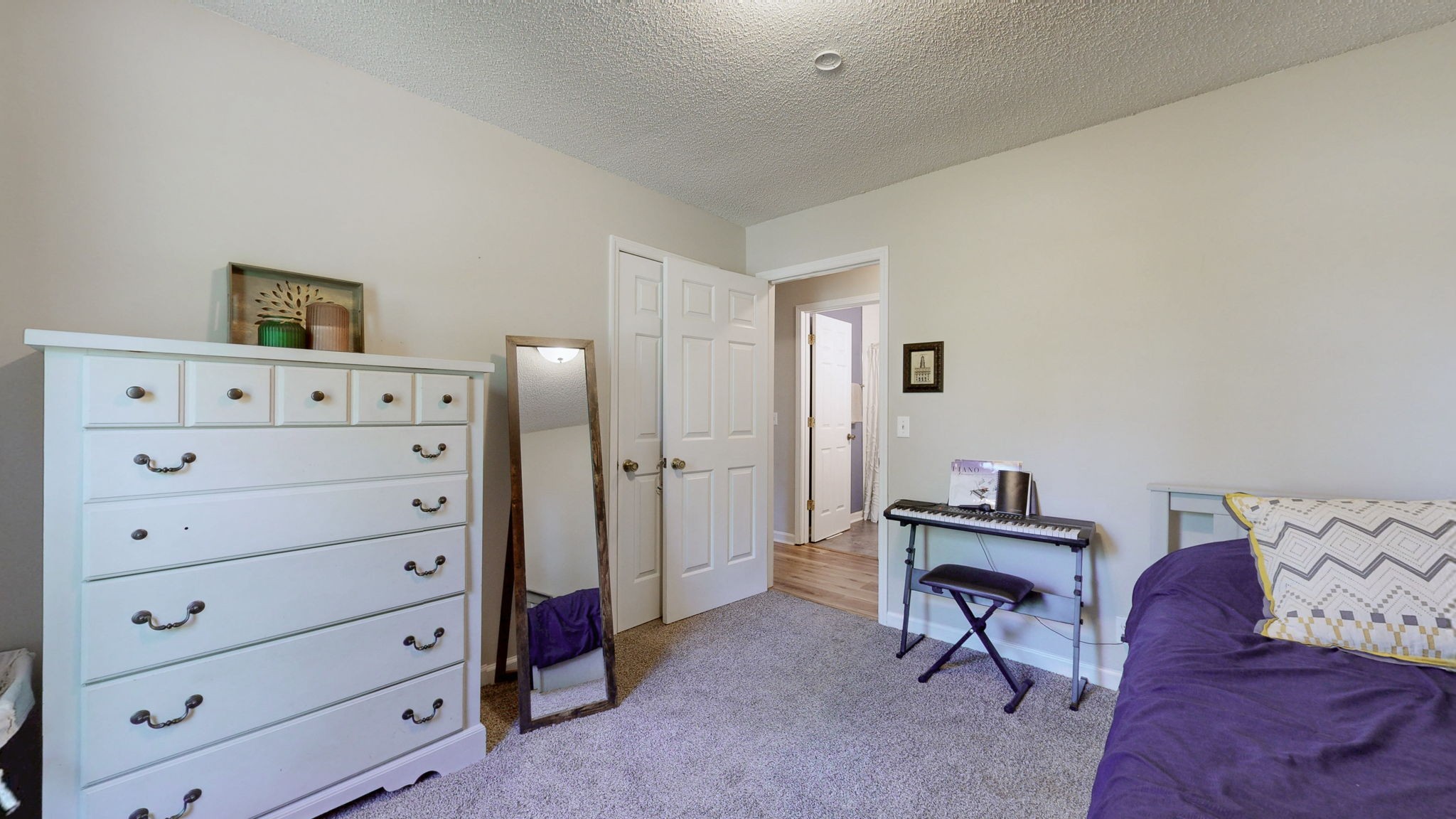 268 Raymond Hodges Road Cottontown, TN 37048 - Photo 21 of 38 a bedroom with a bed and a dresser in it