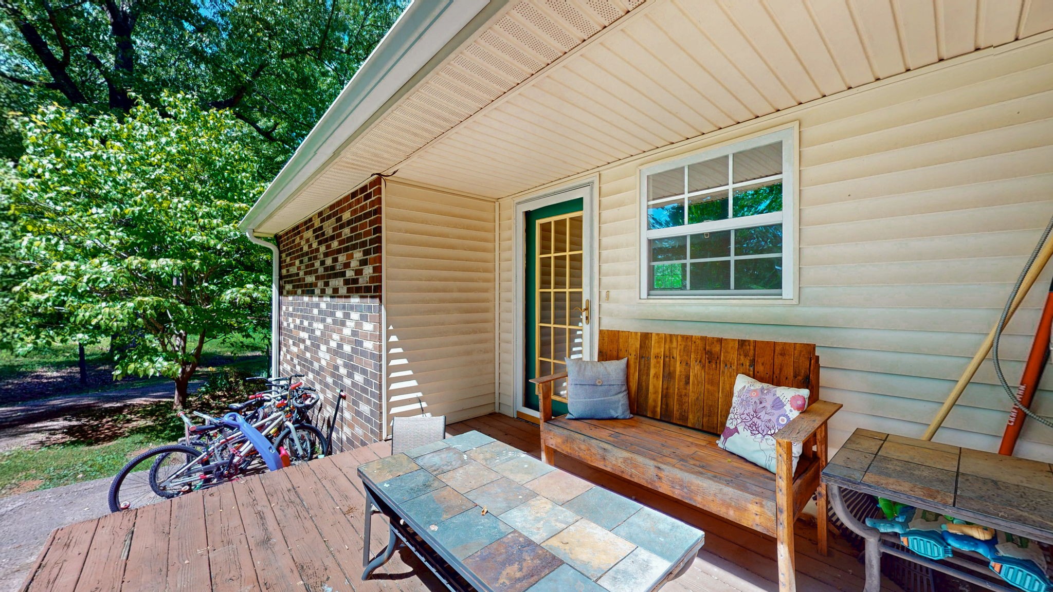 268 Raymond Hodges Road Cottontown, TN 37048 - Photo 35 of 38 a view of a patio with couches table and chairs and potted plants