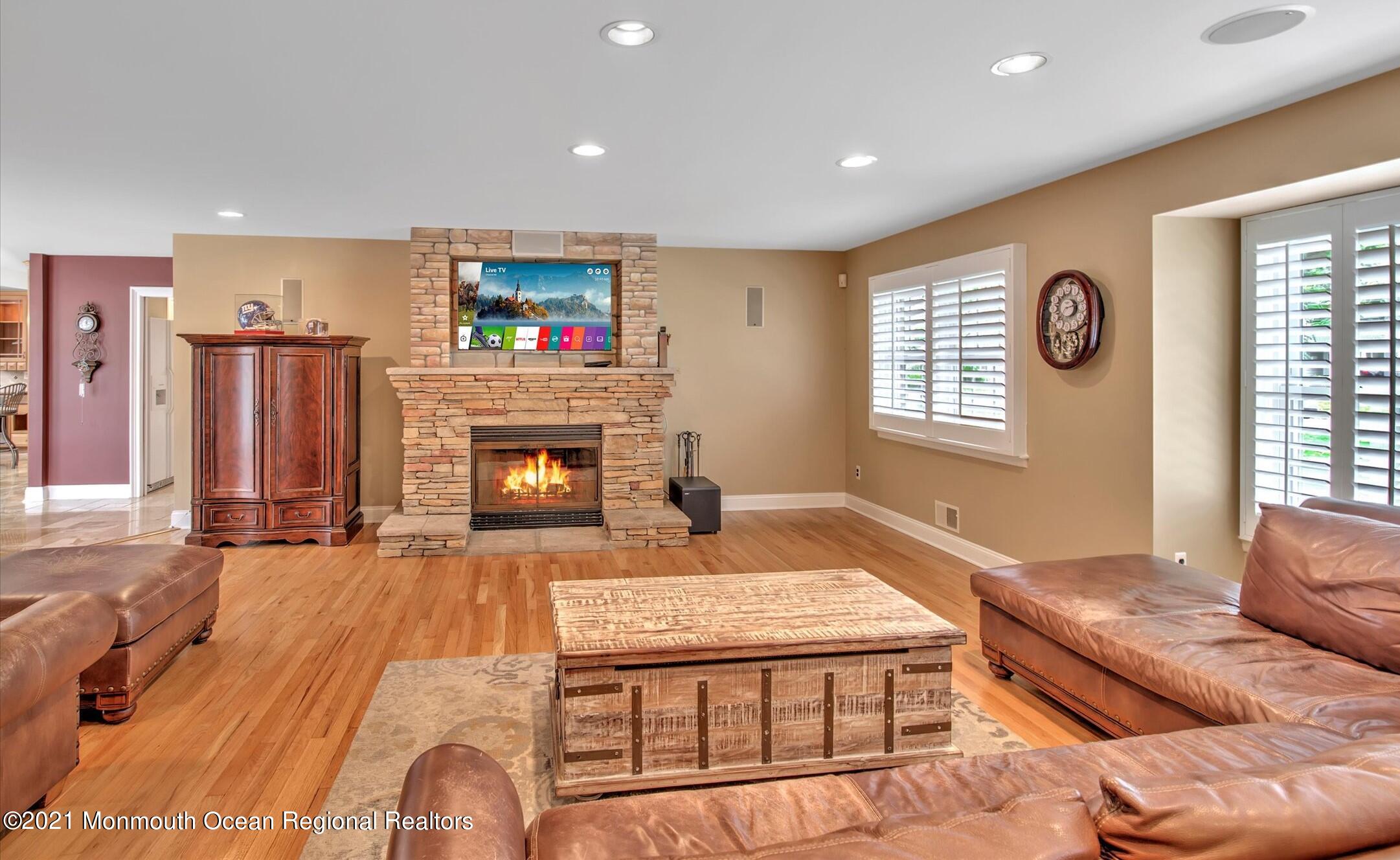 74 Sargent Road Freehold, NJ 07728 - Photo 2 of 23 a living room with furniture pool table and a fireplace