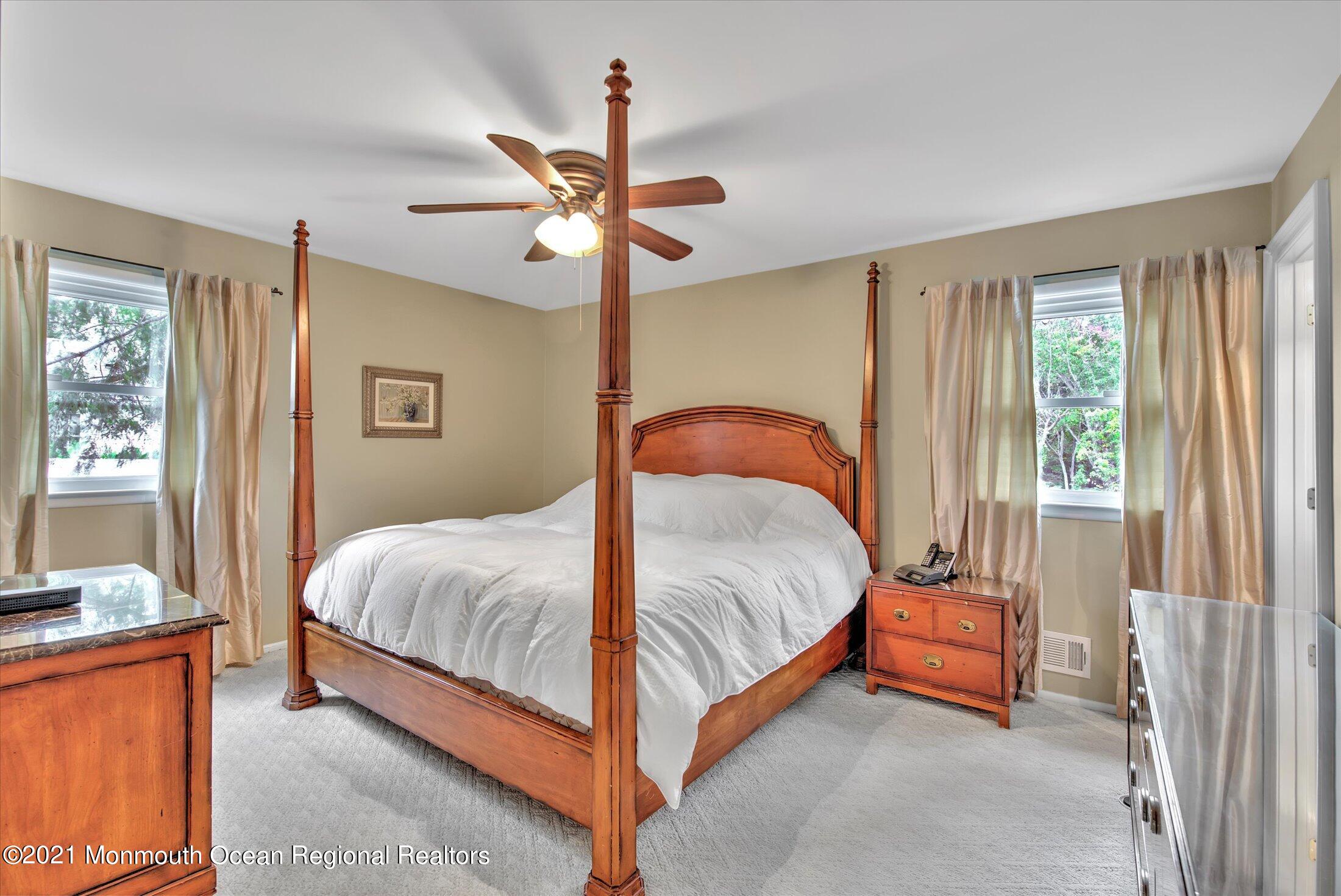 74 Sargent Road Freehold, NJ 07728 - Photo 13 of 23 a bedroom with a bed and a chandelier