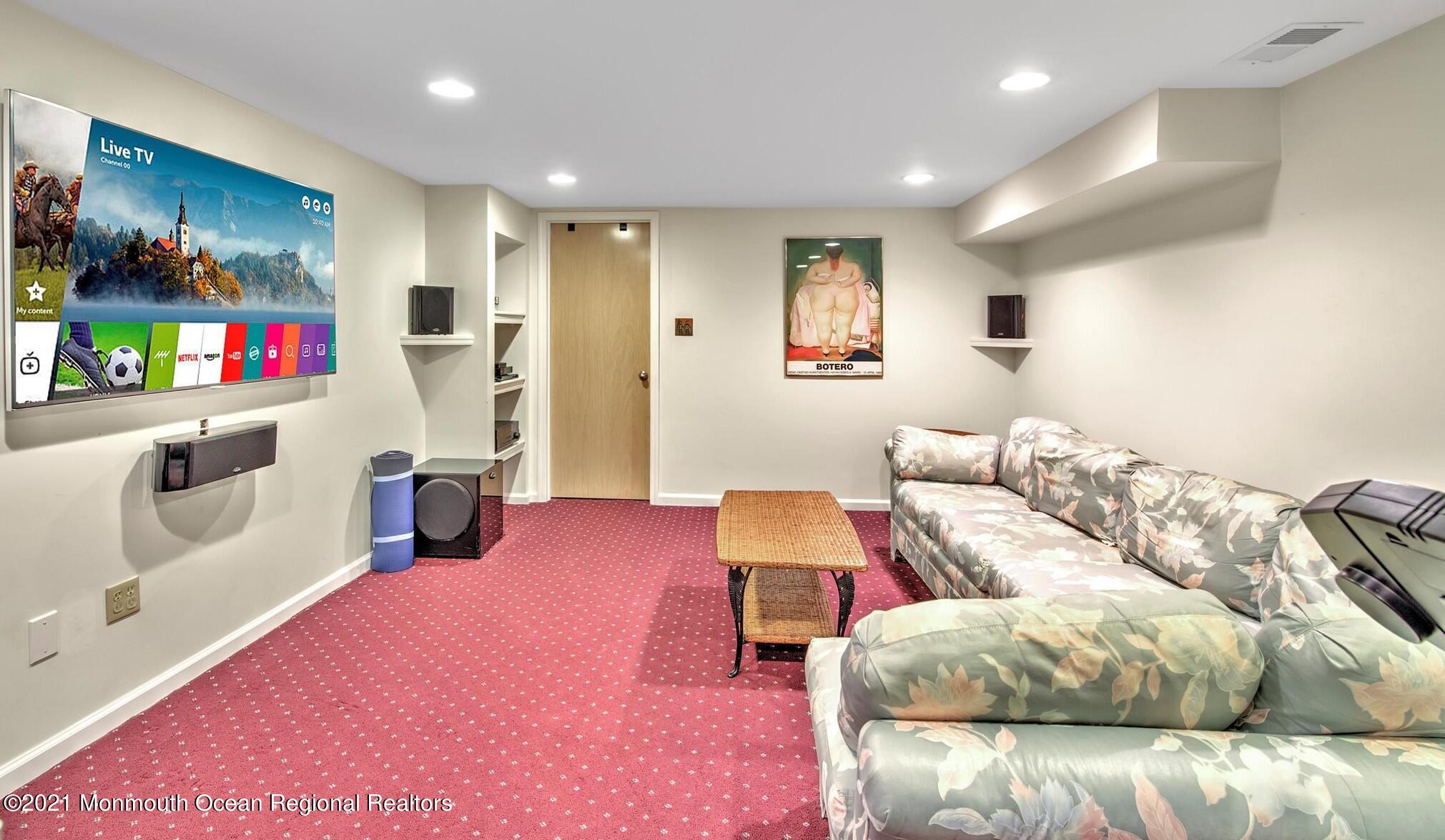 74 Sargent Road Freehold, NJ 07728 - Photo 19 of 23 a living room with furniture and a flat screen tv