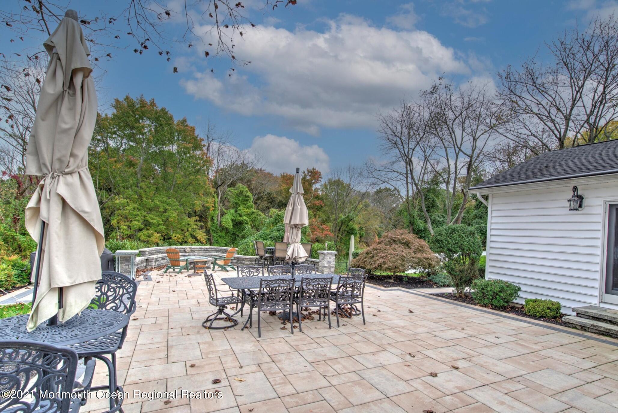 74 Sargent Road Freehold, NJ 07728 - Photo 21 of 23 a view of a patio with a table and chairs and potted plants