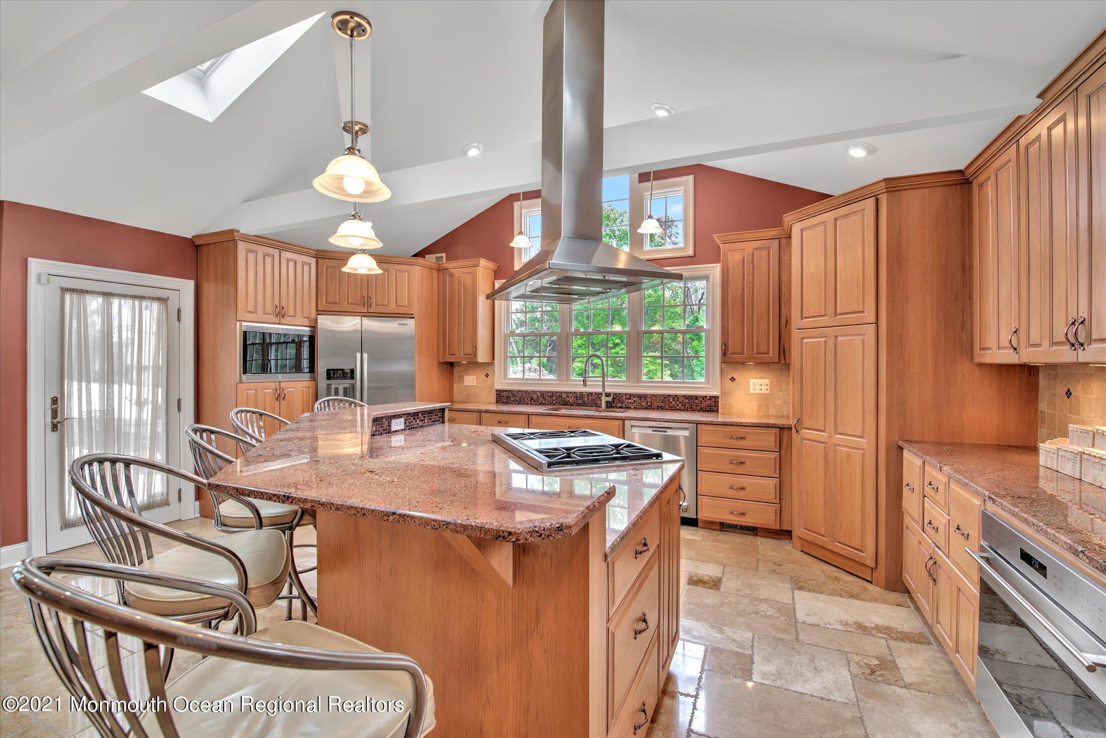 74 Sargent Road Freehold, NJ 07728 - Photo 8 of 23 a kitchen with kitchen island granite countertop a sink cabinets and window