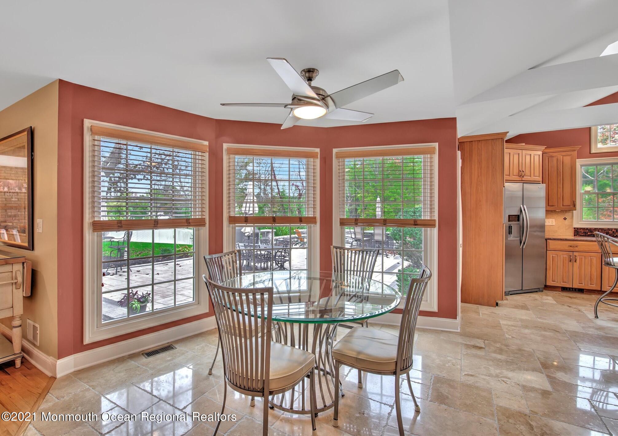 74 Sargent Road Freehold, NJ 07728 - Photo 10 of 23 a dining room with furniture a chandelier and wooden floor