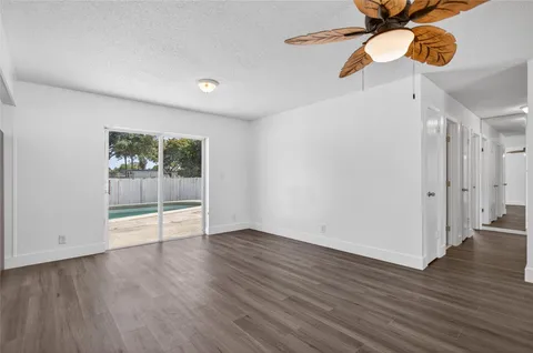 a view of a kitchen with wooden floor and a sink
