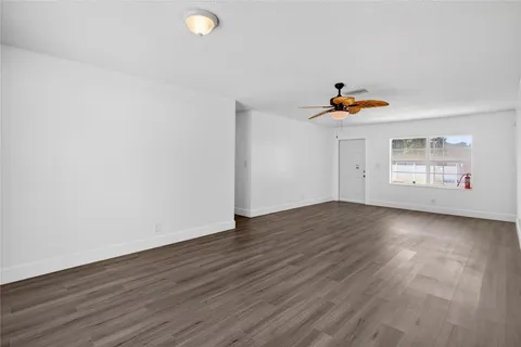 a kitchen with a sink refrigerator and cabinets