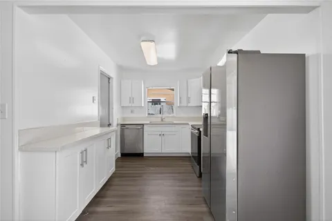 a kitchen with a refrigerator stove and sink