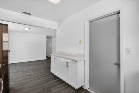 a kitchen with a refrigerator and a sink