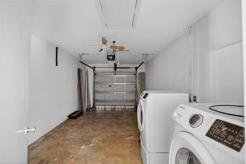 a utility room with sink dryer and washer